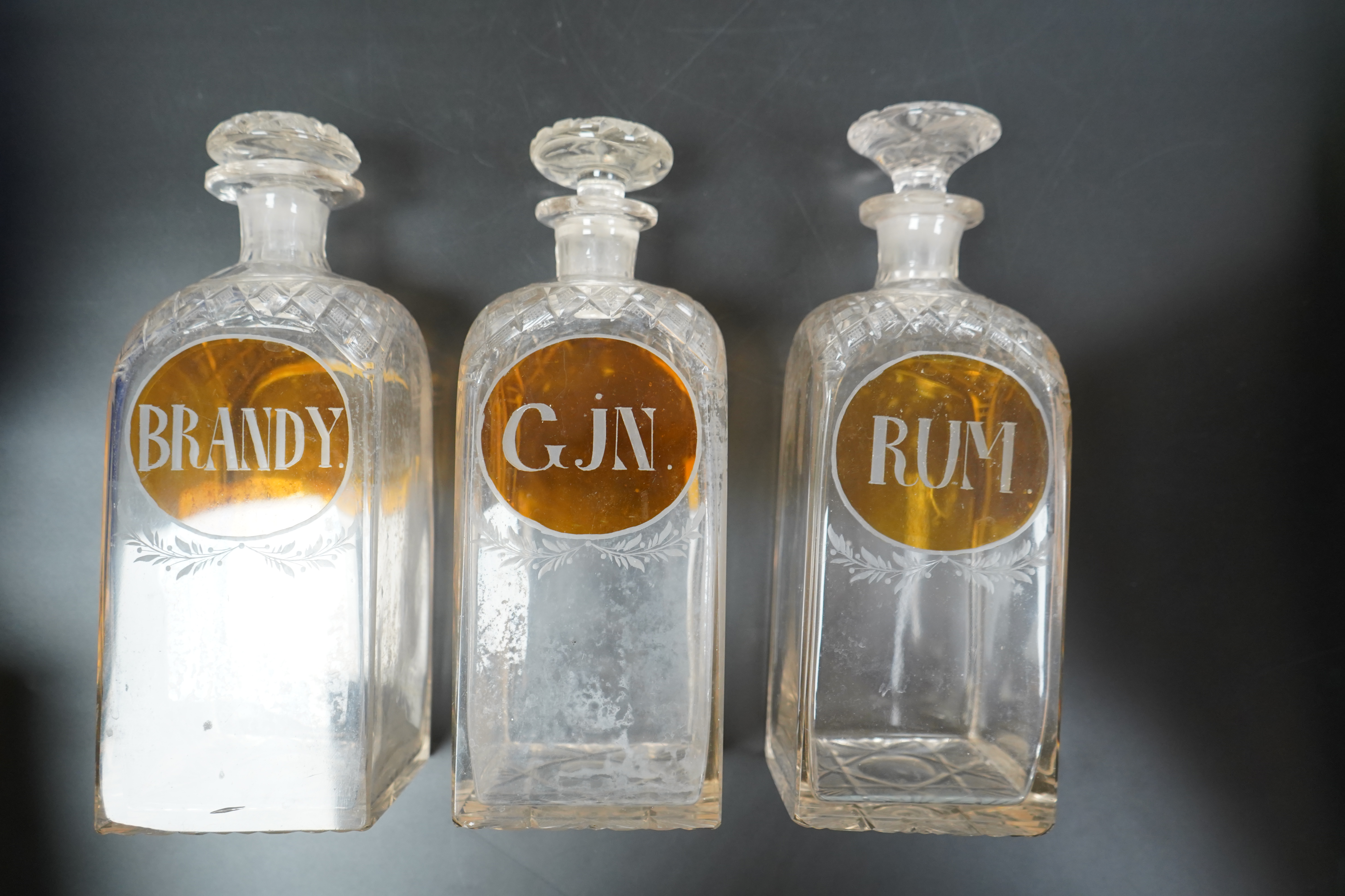 Three 19th century cut glass decanters for 'Rum' 'Gin' and 'Brandy', 23cm high